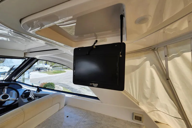 Slide: The Image of Interior of 2019 Regal 35 Sport Coupe with mounted TV and steering area. - 16