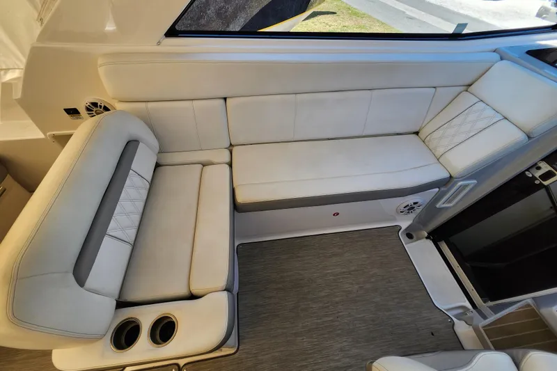 Slide: The Image of 2019 Regal 35 Sport Coupe interior with beige seating and cup holders. - 17