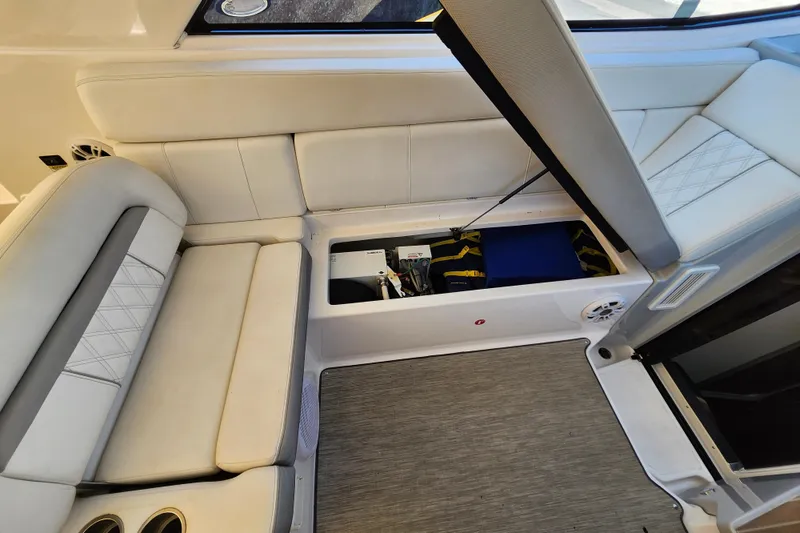 Slide: The Image of 2019 Regal 35 Sport Coupe interior with open storage compartment under white seating. - 18