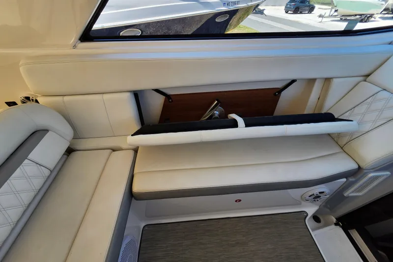 Slide: The Image of 2019 Regal 35 Sport Coupe interior with white leather seating and storage compartment. - 19