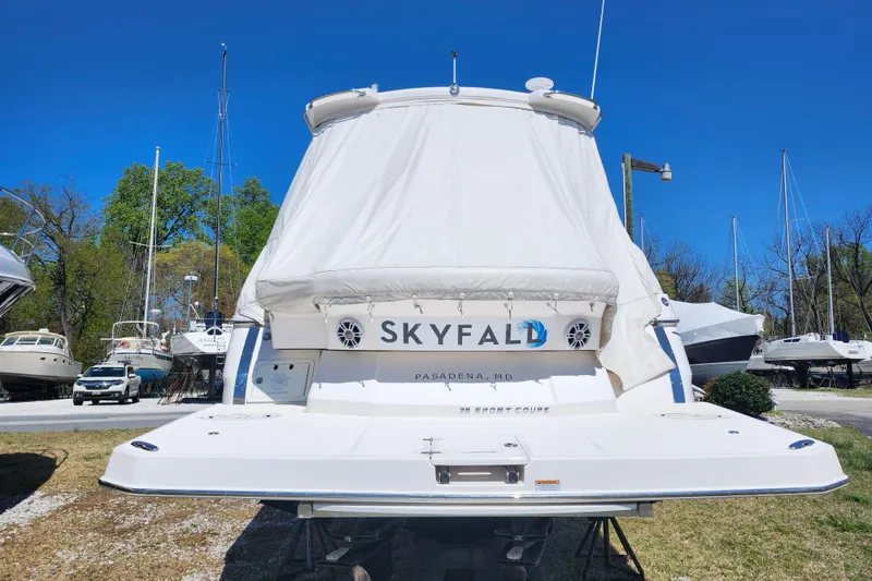 Slide: The Image of 2019 Regal 35 Sport Coupe boat named "Skyfall" in a marina setting. - 2
