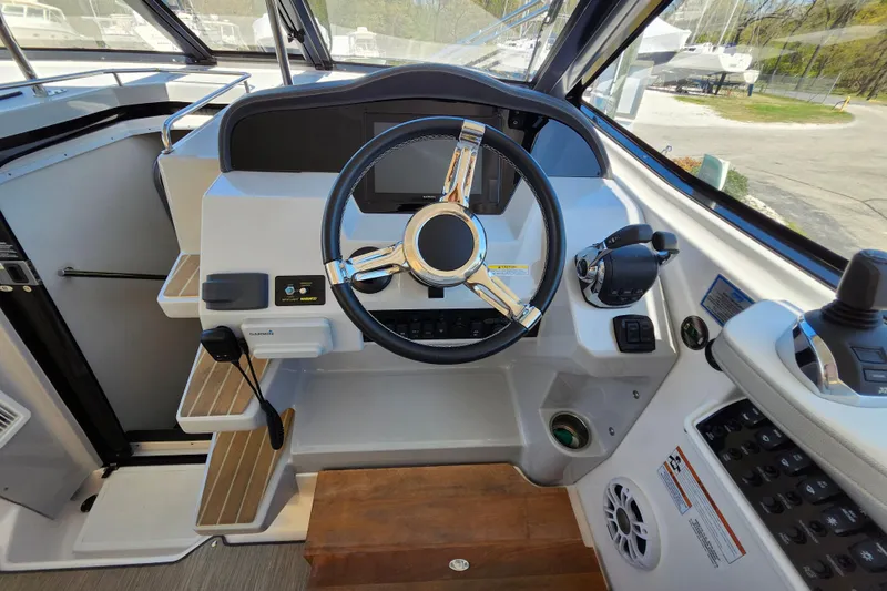 Slide: The Image of 2019 Regal 35 Sport Coupe helm with steering wheel and control panel. - 23
