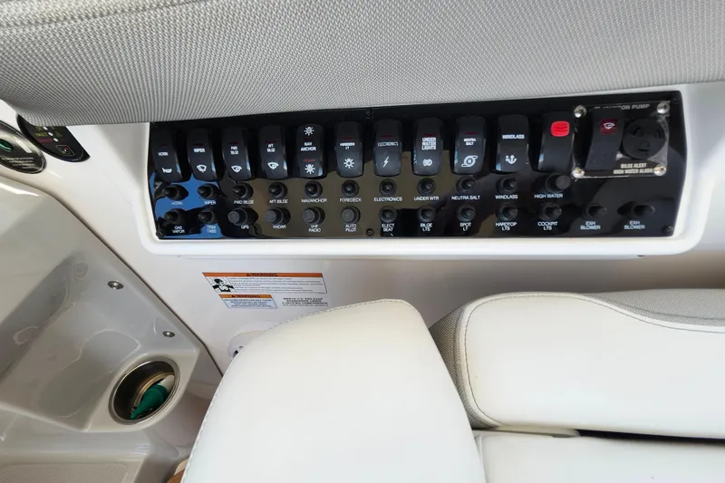 Slide: The Image of Control panel of a 2019 Regal 35 Sport Coupe boat with labeled switches. - 24