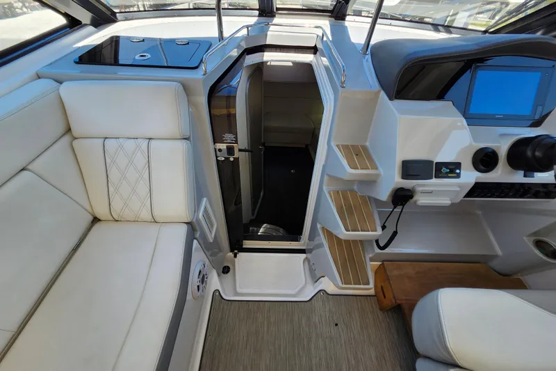 Slide: The Image of Interior of a 2019 Regal 35 Sport Coupe, featuring seating and helm controls. - 25