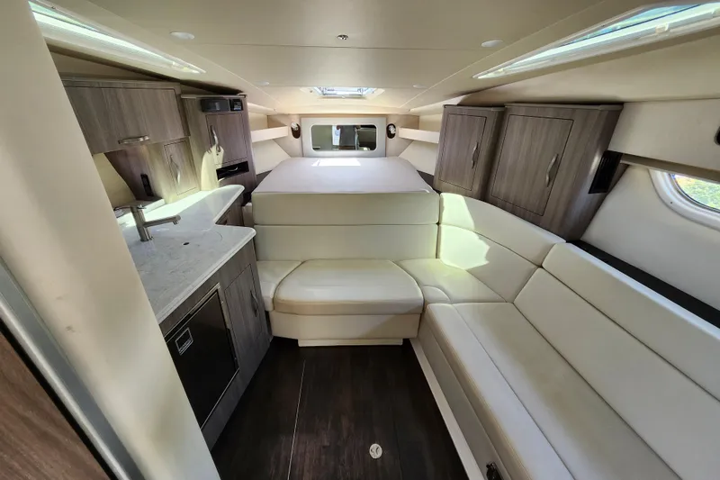 Slide: The Image of Interior of 2019 Regal 35 Sport Coupe with modern kitchen and seating area. - 26