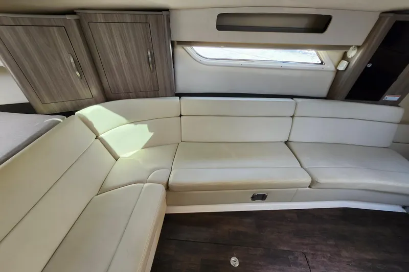 Slide: The Image of Interior of 2019 Regal 35 Sport Coupe with beige seating and wooden cabinets. - 28