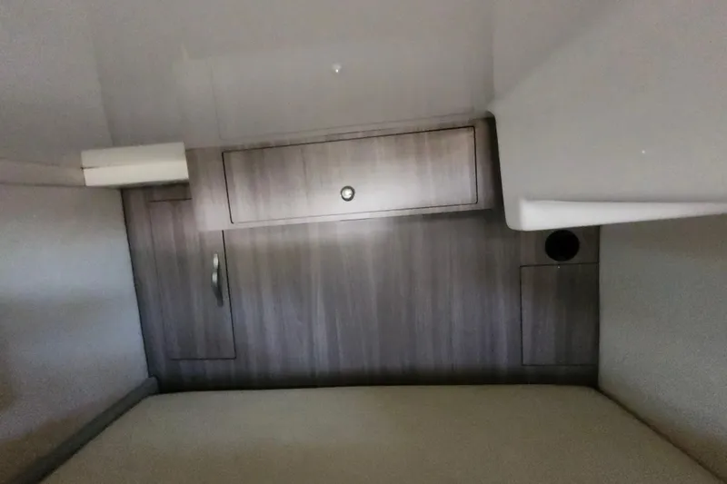 Slide: The Image of 2019 Regal 35 Sport Coupe interior cabin with wood paneling and storage compartments. - 31