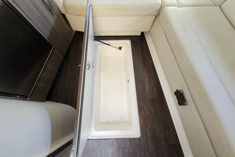Slide: The Image of Underfloor storage compartment in 2019 Regal 35 Sport Coupe boat interior. - 33