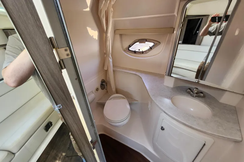 Slide: The Image of Bathroom interior of 2019 Regal 35 Sport Coupe with sink, toilet, and mirror. - 34