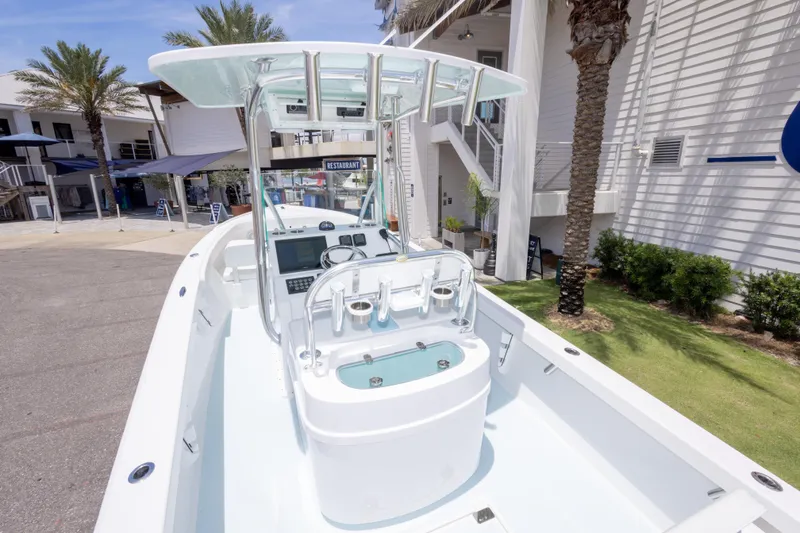 Slide: The Image of 2026 Albury Brothers 23 Forward Seating boat docked near a restaurant, showcasing sleek design. - 19