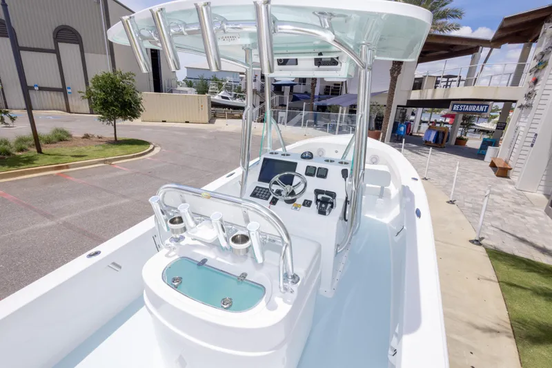 Slide: The Image of 2026 Albury Brothers 23 Forward Seating boat at a marina, showcasing helm and seating area. - 20