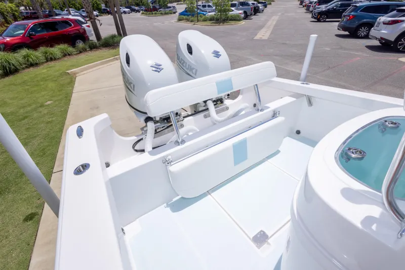Slide: The Image of 2026 Albury Brothers 23 Forward Seating boat with dual Suzuki engines in a parking lot. - 21