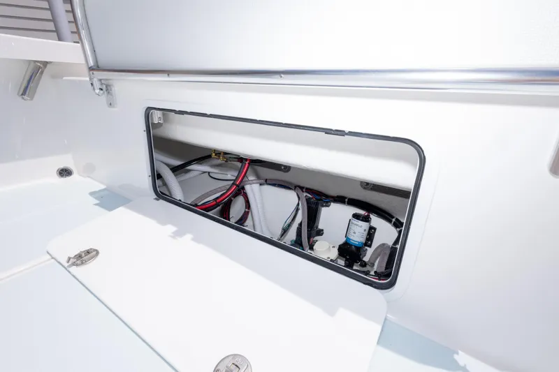 Slide: The Image of 2026 Albury Brothers 23 Forward Seating boat compartment with visible wiring and components. - 24