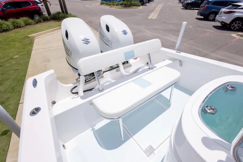 Slide: The Image of 2026 Albury Brothers 23 Forward Seating boat with dual Suzuki engines in a parking lot. - 25