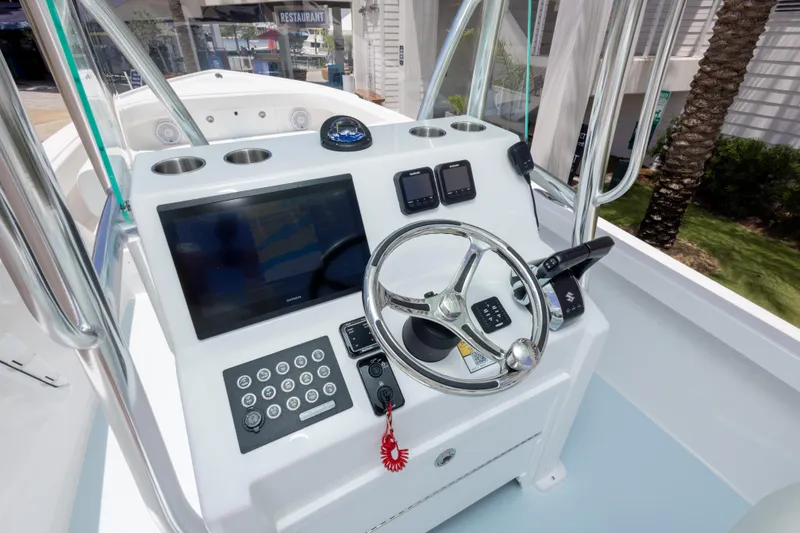 Slide: The Image of 2026 Albury Brothers 23 Forward Seating boat dashboard with steering wheel and navigation controls. - 30