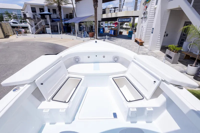 Slide: The Image of 2026 Albury Brothers 23 Forward Seating boat at a marina, showcasing spacious seating and storage. - 44