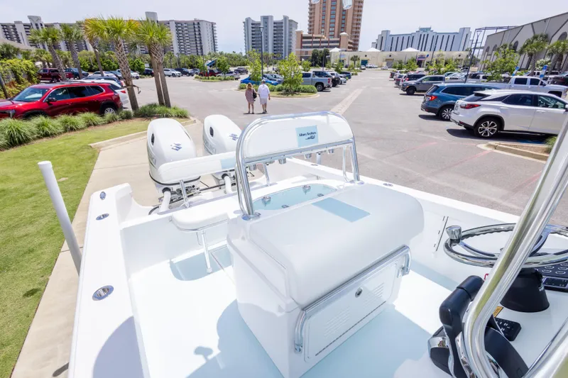 Slide: The Image of 2026 Albury Brothers 23 Forward Seating boat in a parking lot with buildings in the background. - 49