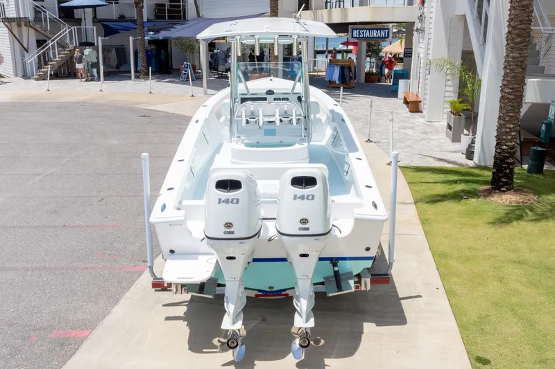 Slide: The Image of 2026 Albury Brothers 23 Forward Seating boat with twin 140 engines, docked near a restaurant. - 52