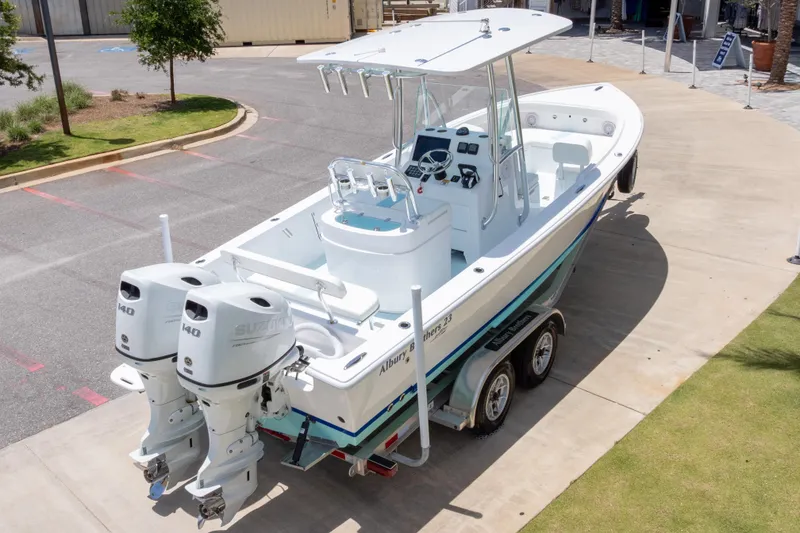 Slide: The Image of 2026 Albury Brothers 23 Forward Seating boat with dual Suzuki engines on a trailer. - 53
