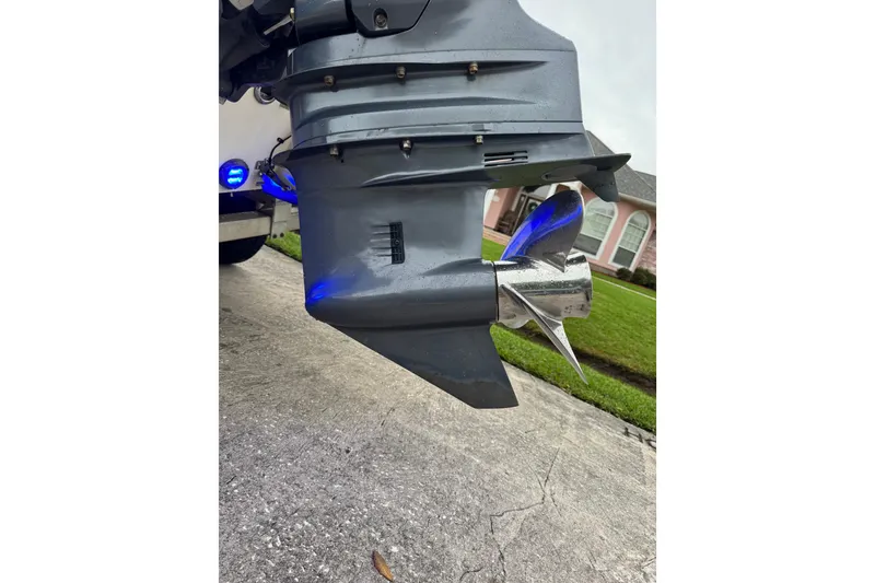 Slide: The Image of 2017 Robalo R200 Center Console boat propeller with blue lighting on driveway. - 13