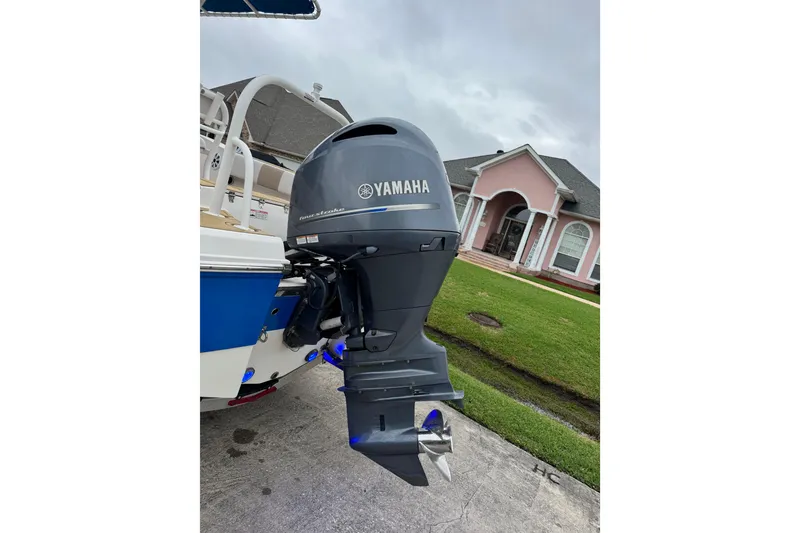 Slide: The Image of 2017 Robalo R200 Center Console with Yamaha outboard motor, parked in residential driveway. - 14
