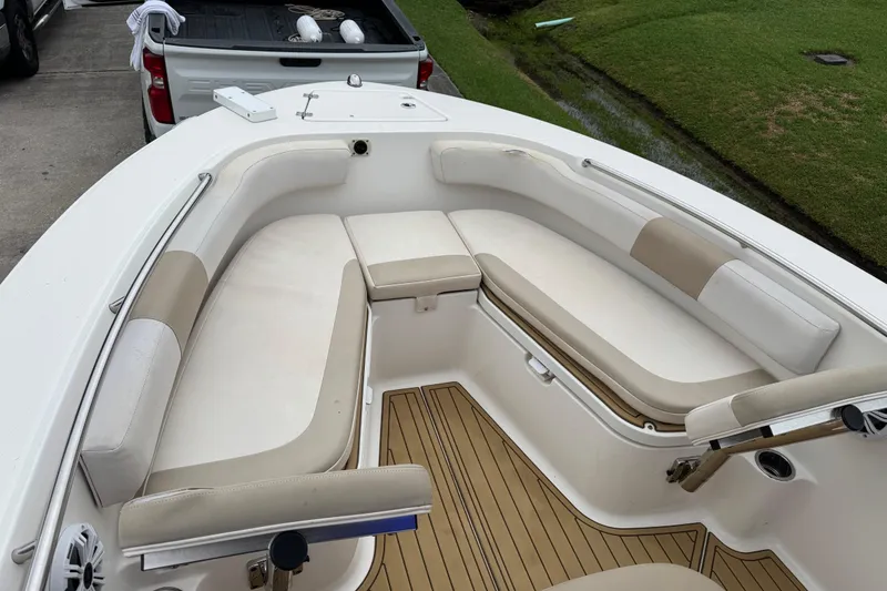 Slide: The Image of 2017 Robalo R200 Center Console boat with cushioned seating and teak flooring. - 17