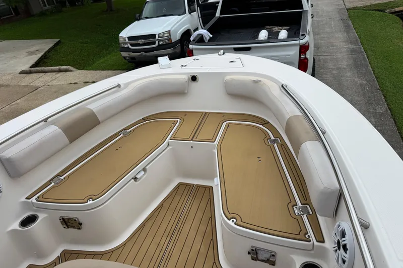 Slide: The Image of 2017 Robalo R200 Center Console boat interior with cushioned seating and storage compartments. - 19