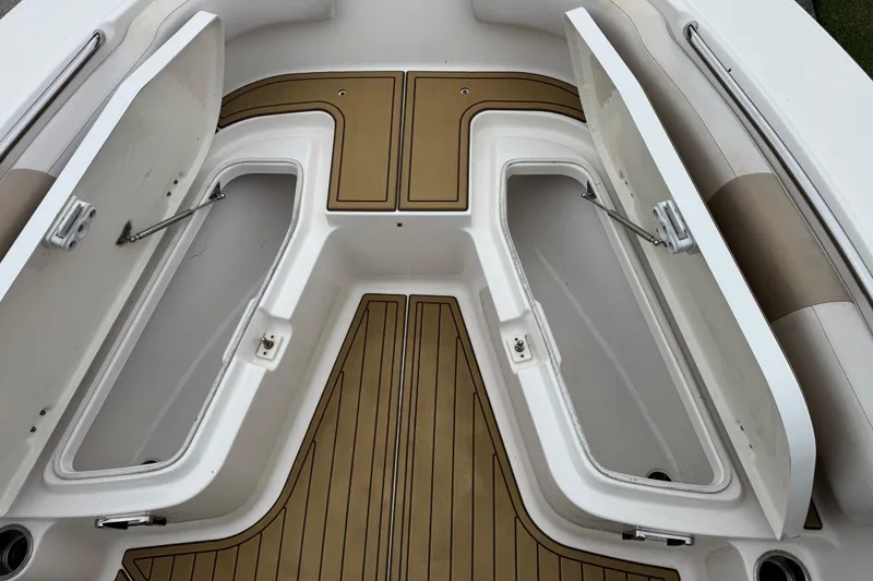 Slide: The Image of 2017 Robalo R200 Center Console boat with open storage compartments and teak flooring. - 23