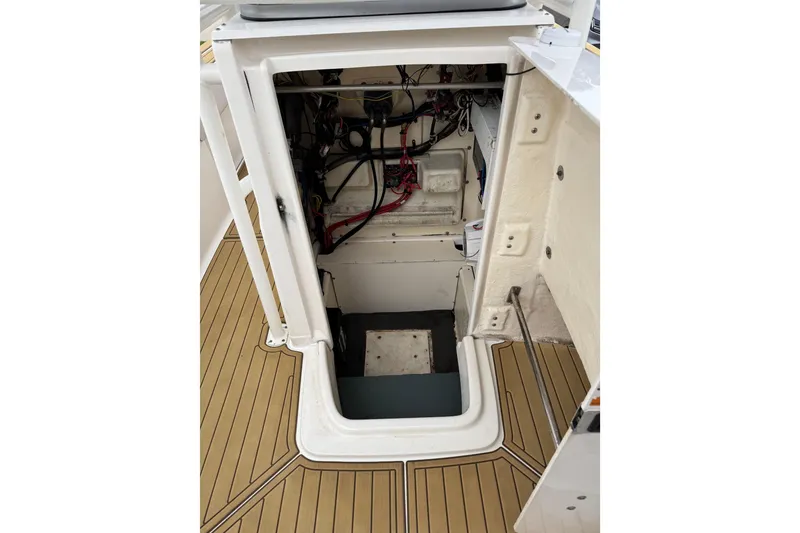 Slide: The Image of 2017 Robalo R200 Center Console boat interior wiring and storage compartment. - 24