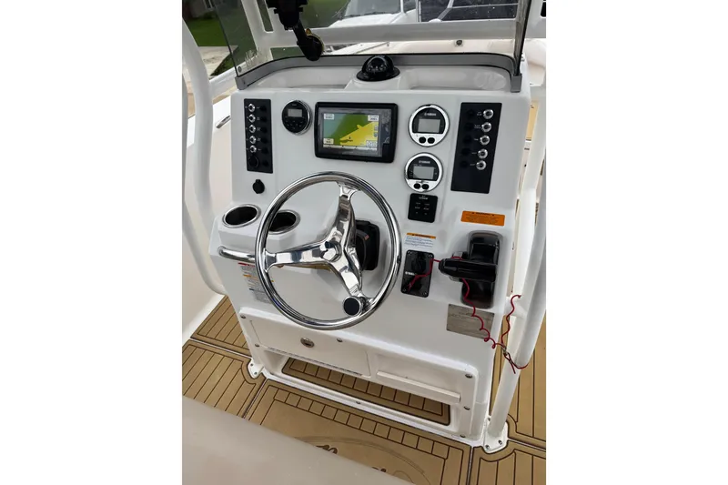 Slide: The Image of 2017 Robalo R200 Center Console dashboard with steering wheel and navigation controls. - 25