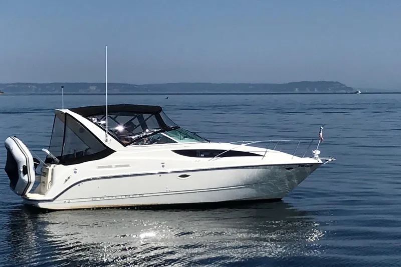 The Image of 2007 Bayliner 285 boat on calm water with distant shoreline. - 0
