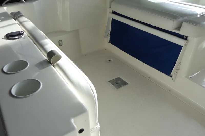 Slide: The Image of 2007 Bayliner 285 boat interior with seating and cup holders. - 12