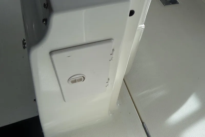 Slide: The Image of 2007 Bayliner 285 boat interior detail showing a white compartment door. - 13