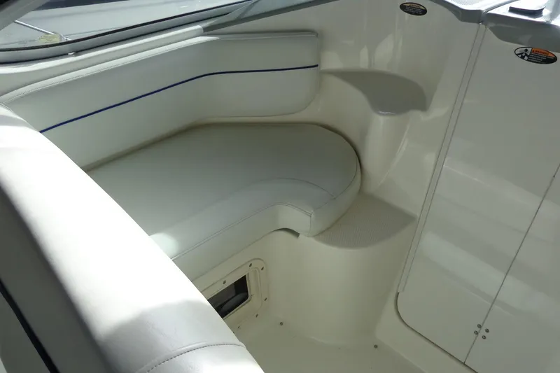 Slide: The Image of Interior seating of a 2007 Bayliner 285 boat, featuring white upholstery. - 15
