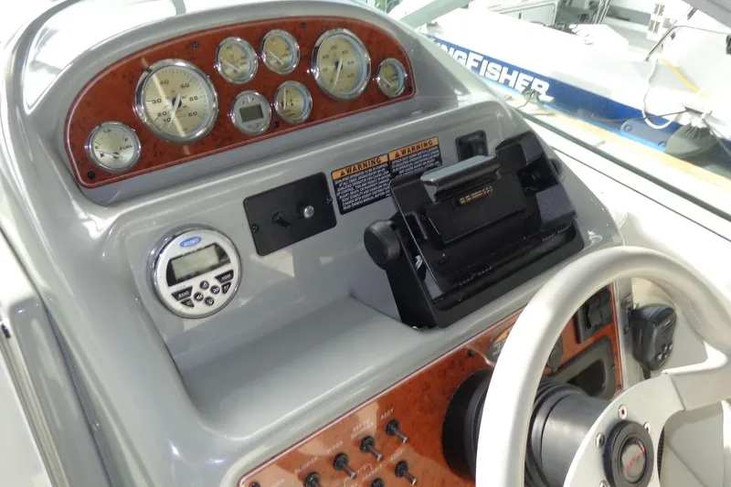 Slide: The Image of Dashboard of a 2007 Bayliner 285 boat with gauges and controls. - 17