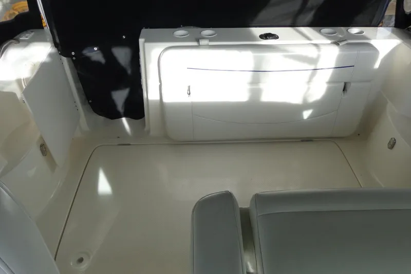 Slide: The Image of 2007 Bayliner 285 boat interior with seating and storage compartments. - 18