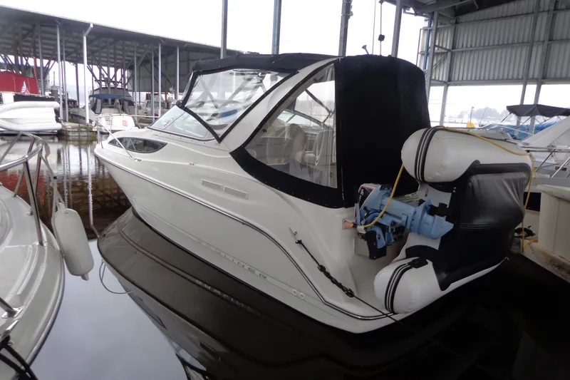 Slide: The Image of 2007 Bayliner 285 boat docked in a marina, featuring a sleek design and covered cockpit. - 3