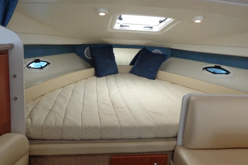 Slide: The Image of Interior cabin of 2007 Bayliner 285 boat with cozy bed and pillows. - 31