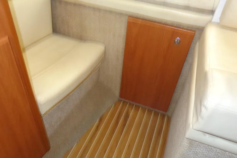Slide: The Image of Interior of 2007 Bayliner 285 boat with beige seating and wooden flooring. - 32
