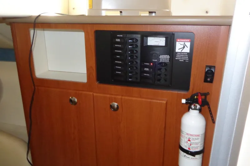 Slide: The Image of Control panel and fire extinguisher on 2007 Bayliner 285 boat interior. - 36