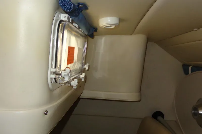 Slide: The Image of Interior view of a 2007 Bayliner 285 boat, featuring a compact cabin window. - 39