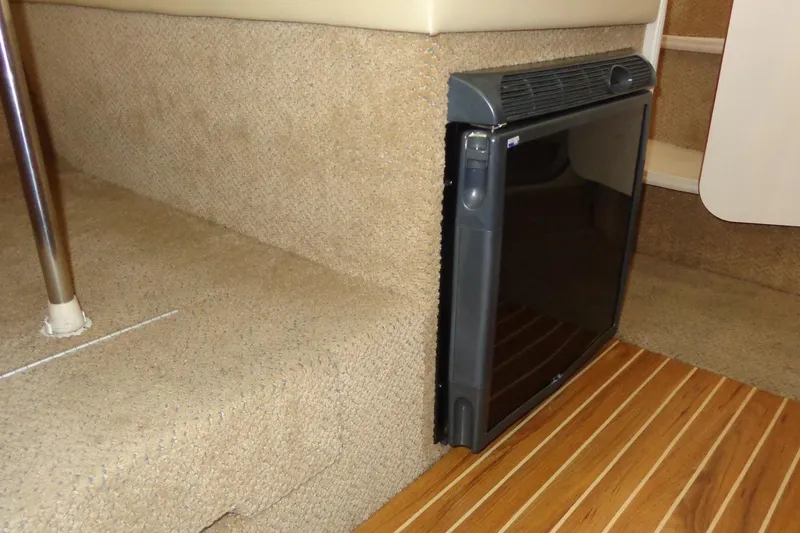 Slide: The Image of 2007 Bayliner 285 interior with carpeted steps and compact refrigerator. - 40