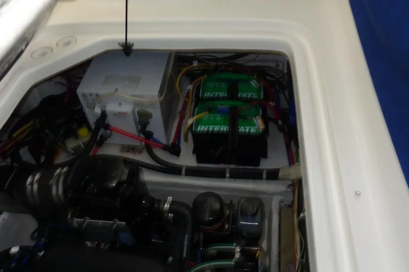Slide: The Image of Engine compartment of a 2007 Bayliner 285 with visible batteries and wiring. - 47