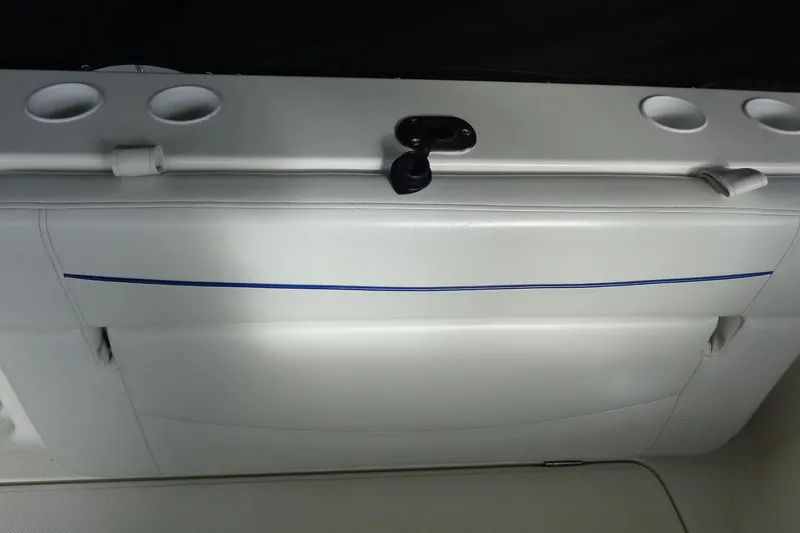 Slide: The Image of 2007 Bayliner 285 boat interior with white seating and cup holders. - 49