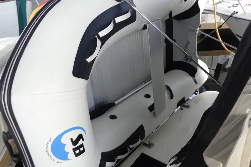 Slide: The Image of Inflatable boat attached to a 2007 Bayliner 285 yacht, docked at a marina. - 50