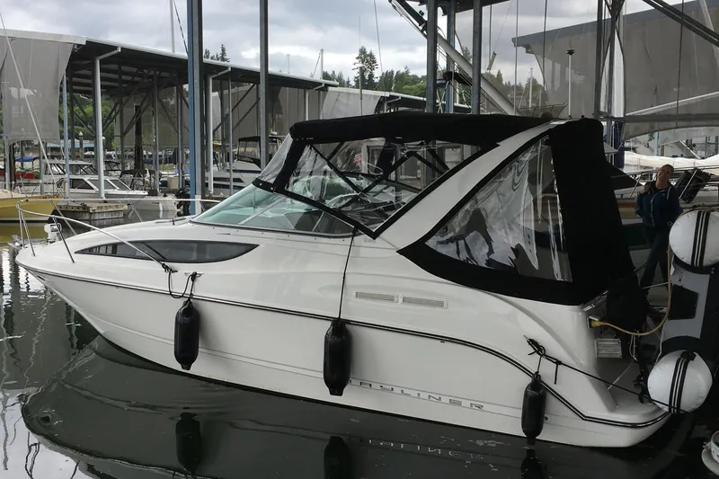 Slide: The Image of 2007 Bayliner 285 boat docked in a marina with protective canopy. - 53