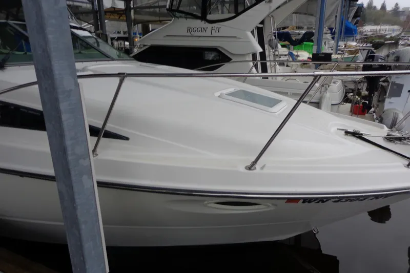 Slide: The Image of 2007 Bayliner 285 boat docked in marina, white exterior, sleek design. - 7
