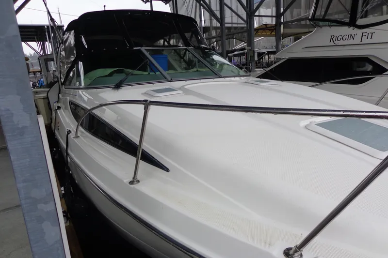Slide: The Image of 2007 Bayliner 285 boat docked in a marina, featuring sleek design and white exterior. - 9