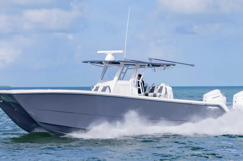 Slide: The Image of 2023 Invincible 35 Catamaran cruising on open water, showcasing sleek design and powerful engines. - 11