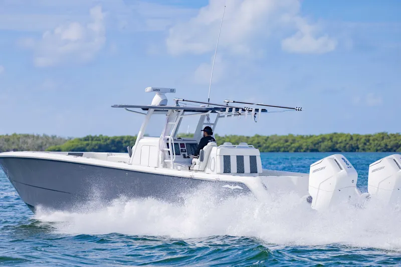 Slide: The Image of 2023 Invincible 35 Catamaran cruising on open water, showcasing sleek design and powerful engines. - 12